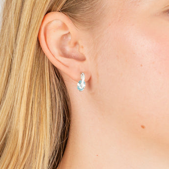Sterling Silver Rhodium Plated Light Blue And White CZ Crossover Stud Earrings